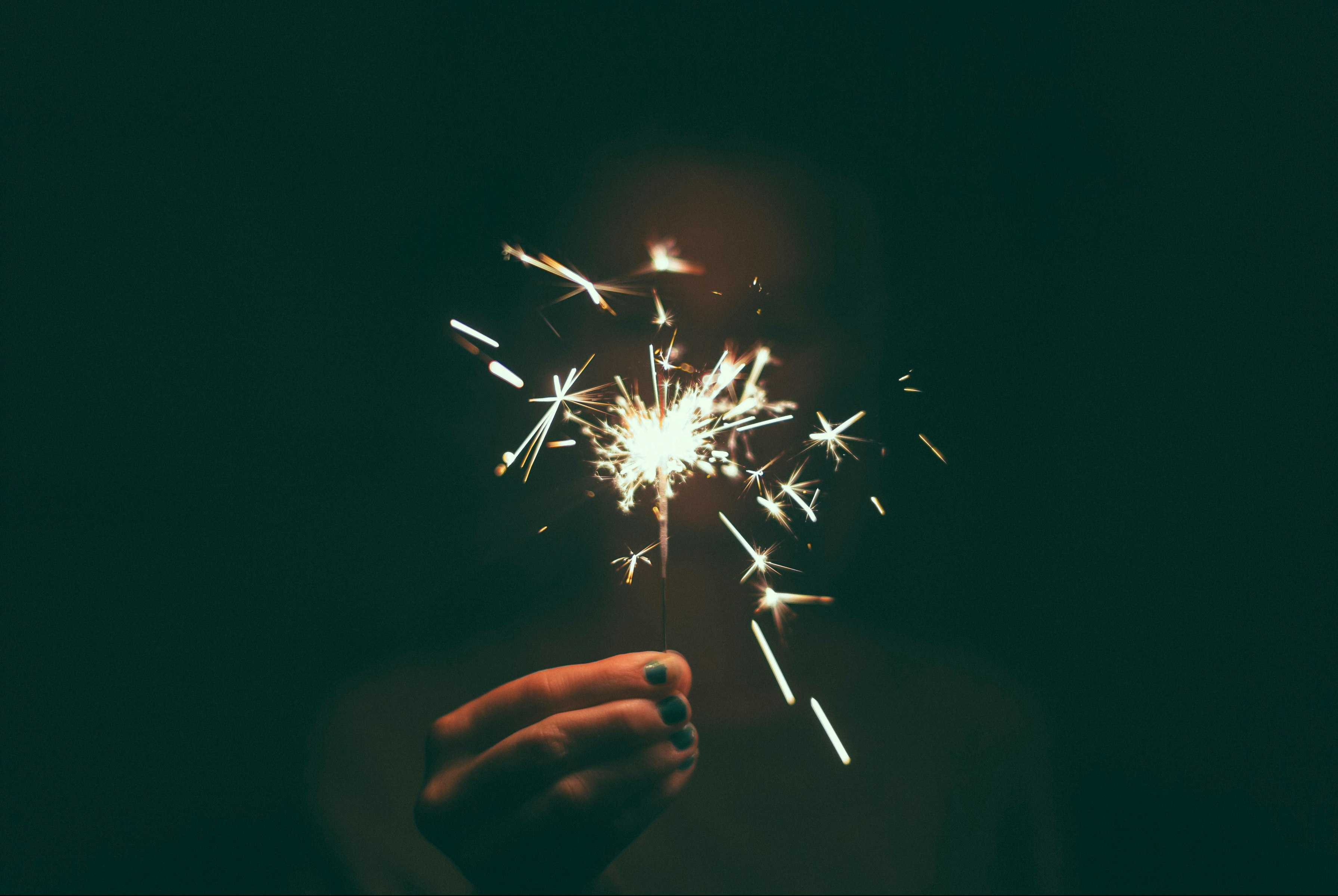 person holding lighted sparkler